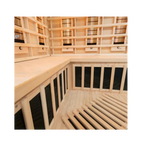Close-up of interior bench area in Miracle Sauna 4 Person Corner Far Infrared Sauna highlighting wooden finish and heater layout
